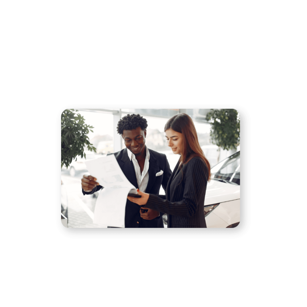 Powerful CDP Solutions for Personalized Customer Experiences hero in colour two people reviewing a contract with a car in the background